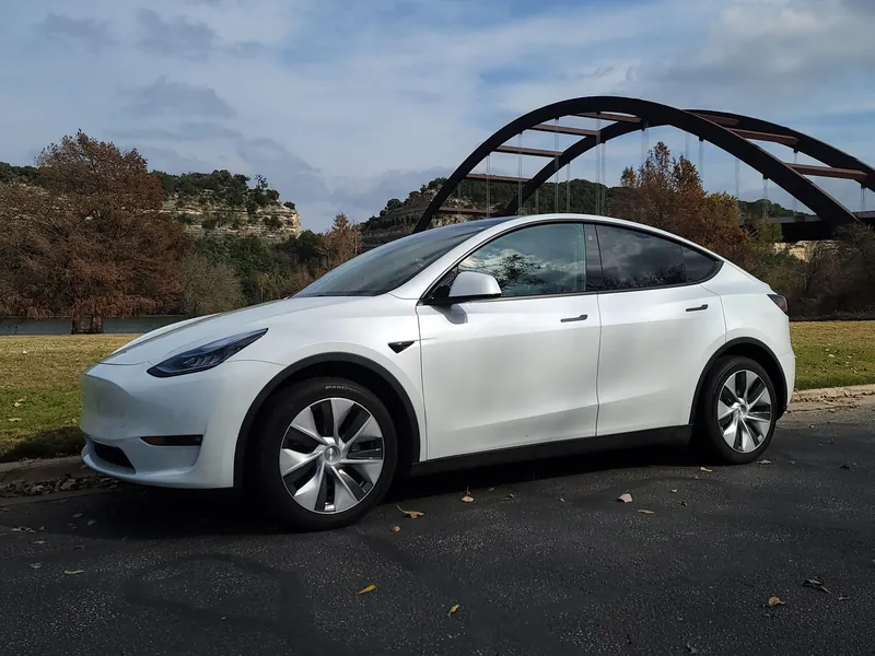 White Tesla Model Y parked near the Pennybacker Bridge in Austin