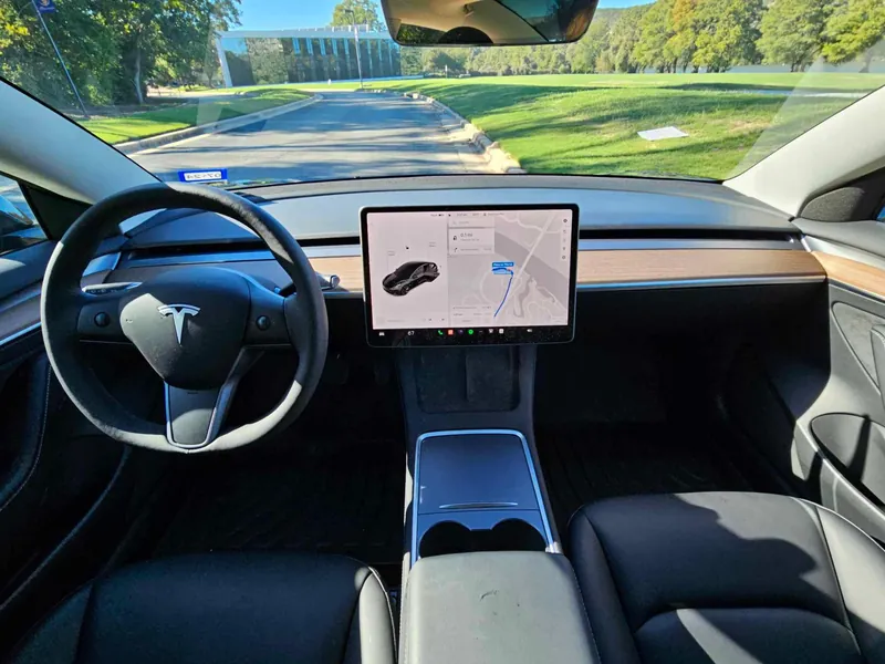 Tesla Model 3 interior with touchscreen and steering wheel