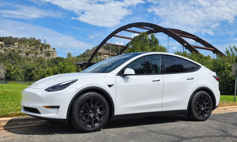 White Tesla Model Y rental by the Pennybacker Bridge