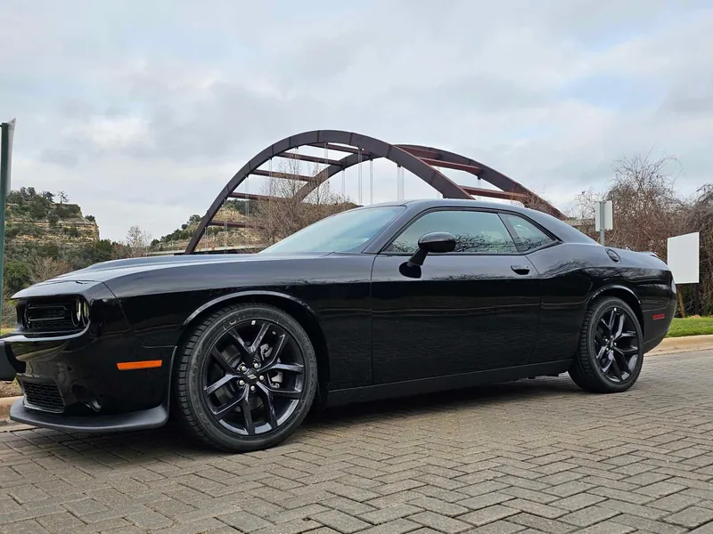 Black Dodge Challenger parked by the Pennybacker Bridge in Austin